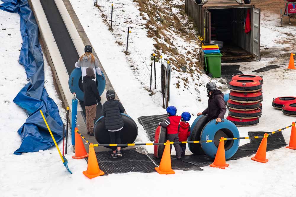 Waiting in line for the magic carpet to snow tube at Tekapo Springs, Canterbury, New Zealand