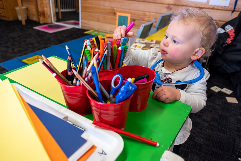 Emilia from Backyard Travel Family steals a pen from the art supplies inside Skiwland at Mt Hutt Skifield, near Christchurch, New Zealand