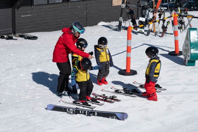 Skiwi Kids start their ski lesson, outside the childcare centre/preschool at Mt Hutt Skifield, Methven, NZ