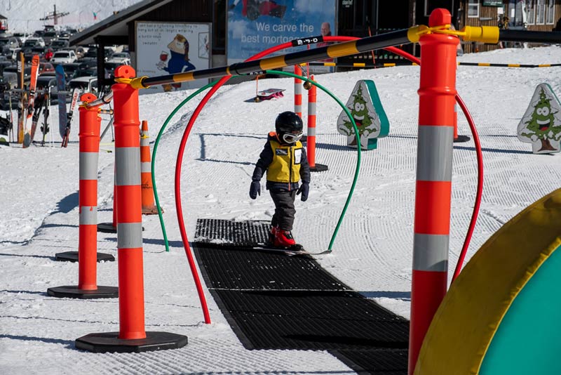 Kipton from Backyard Travel Family walks up the rubber mats in the Skiwi Kids group lesson at Mt Hutt Skifield, Canterbury, NZ