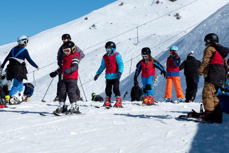 Nathan from Backyard Travel Family leads the Kea Club students on the learners slope at Mt Hutt Skifield, Methven, New Zealand