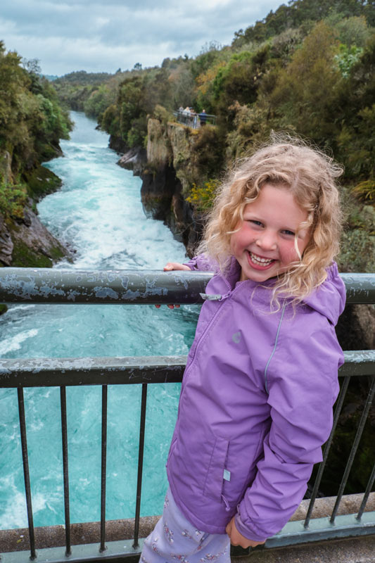 emilia stands on a bridge overlooking huka falls taupo