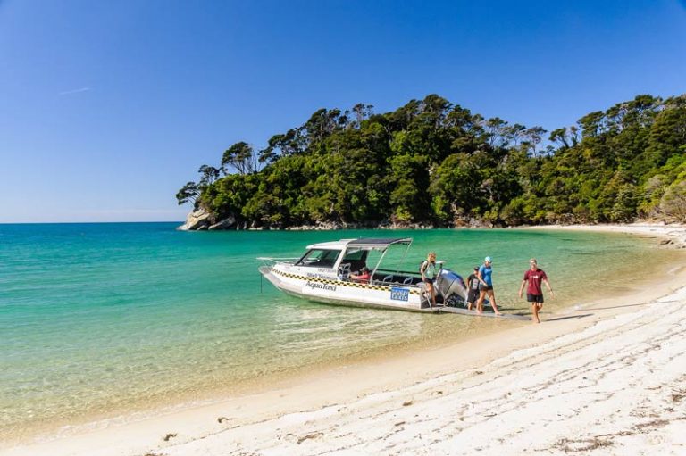 Tourists offload the Abel Tasman Aquataxi in the Abel Tasman National Park