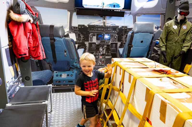 Kipton from Backyard Travel Family excites in the simulation of an Aircraft getting reading to take its freight to Antarctica