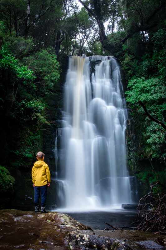 Nathan from Backyard Travel Family stands atop McLean Falls, Catlins, New Zealand