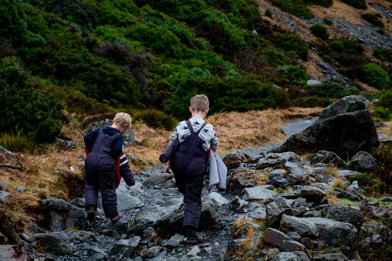 Nathan and Kipton from Backyard Travel Family hike up the short Kea Point Track to the viewpoint