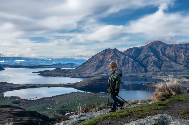 Kipton from Backyard Travel Family walks on top of the Rocky Mountain Wanaka summit, a great half day walk in Wanaka