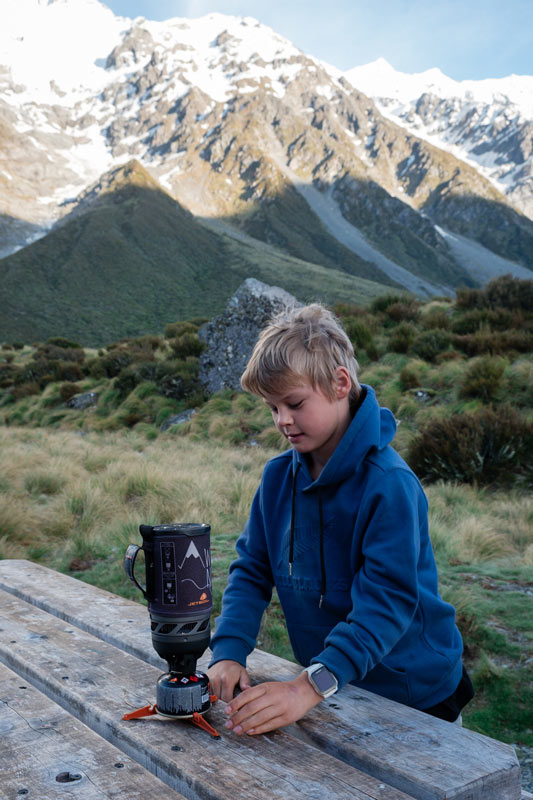 nathan lights a jetboil flash outside the hooker hut in Mt Cook National Park. Its a great piece of tramping gear for kids