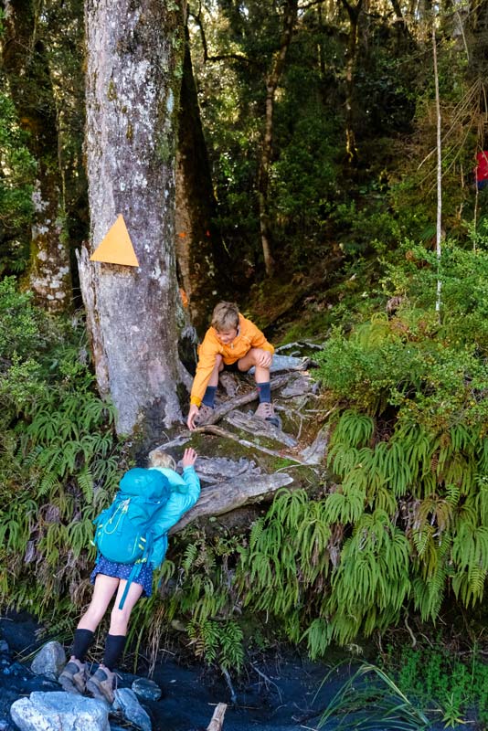 The start of the Brewster Hut track is marked by a big orangle triangle marker